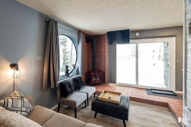 286 W Eagles Roost St Unit A108, Brian Head, UT 84719 - living area with hardwood / wood-style floors, a textured ceiling, and a wood stove