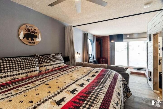 286 W Eagles Roost St Unit A108, Brian Head, UT 84719 - bedroom with multiple windows, wood-type flooring, a textured ceiling, and vaulted ceiling