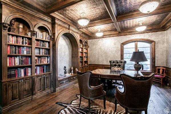 home office with coffered ceiling, crown molding, dark hardwood / wood-style floors, built in features, and beamed ceiling