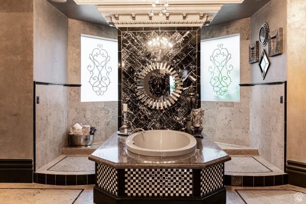 bathroom with tile walls, tile patterned floors, and a bathtub