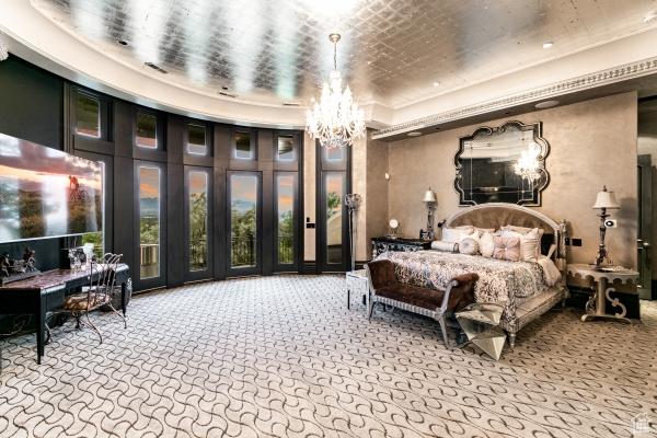 bedroom featuring carpet floors and a notable chandelier