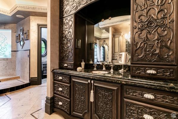 bathroom featuring vanity, tile patterned floors, and ornamental molding