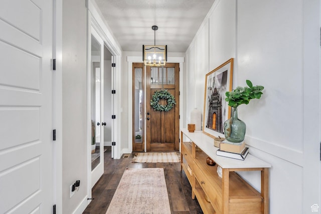668 W Leroy Cir, Saratoga Springs, UT 84045 - foyer entrance with a notable chandelier and dark wood finished floors