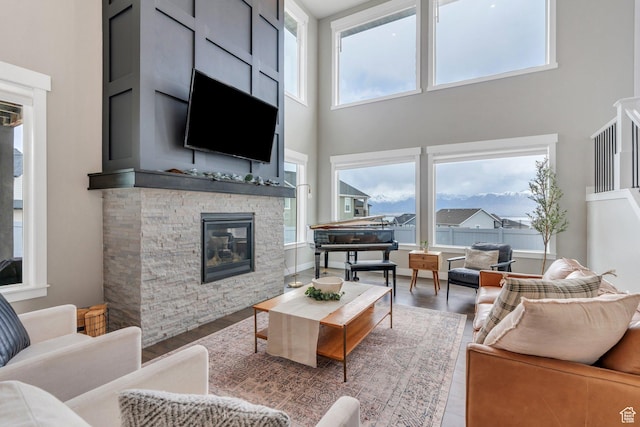 668 W Leroy Cir, Saratoga Springs, UT 84045 - living room featuring a high ceiling, wood finished floors, and a stone fireplace
