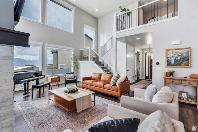 668 W Leroy Cir, Saratoga Springs, UT 84045 - living area featuring stairs, wood finished floors, baseboards, a towering ceiling, and recessed lighting