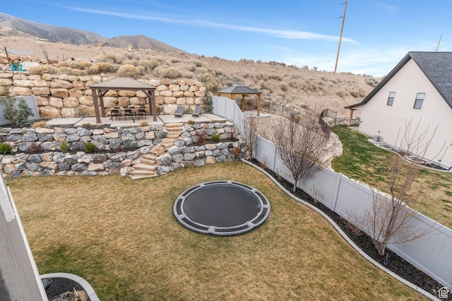 668 W Leroy Cir, Saratoga Springs, UT 84045 - view of yard with a patio, a fenced backyard, a gazebo, a trampoline, and a mountain view