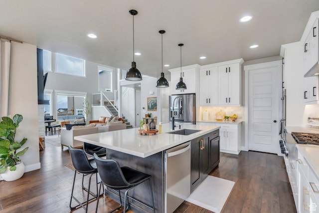 668 W Leroy Cir, Saratoga Springs, UT 84045 - kitchen with open floor plan, light countertops, a sink, and appliances with stainless steel finishes