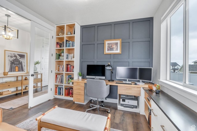 668 W Leroy Cir, Saratoga Springs, UT 84045 - office with a decorative wall, dark wood-style flooring, a chandelier, and built in shelves