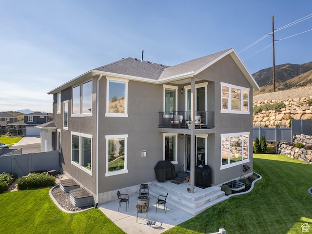668 W Leroy Cir, Saratoga Springs, UT 84045 - rear view of house with a patio area, fence, a balcony, a mountain view, and a yard