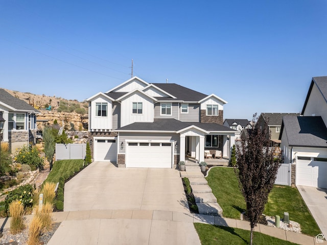 668 W Leroy Cir, Saratoga Springs, UT 84045 - view of front of house featuring driveway, stone siding, fence, board and batten siding, and a garage