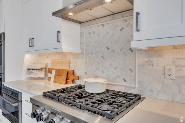 668 W Leroy Cir, Saratoga Springs, UT 84045 - kitchen featuring light countertops, range hood, tasteful backsplash, appliances with stainless steel finishes, and white cabinets