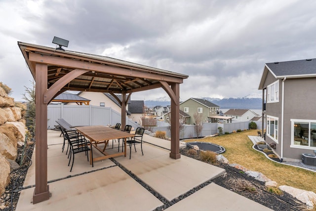 668 W Leroy Cir, Saratoga Springs, UT 84045 - view of patio with central air condition unit, a gazebo, a fenced backyard, outdoor dining space, and a mountain view