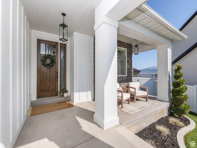 668 W Leroy Cir, Saratoga Springs, UT 84045 - doorway to property featuring covered porch, a mountain view, and fence