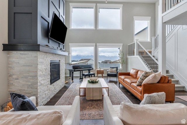 668 W Leroy Cir, Saratoga Springs, UT 84045 - living area featuring a fireplace, dark wood-style floors, a wealth of natural light, and stairway