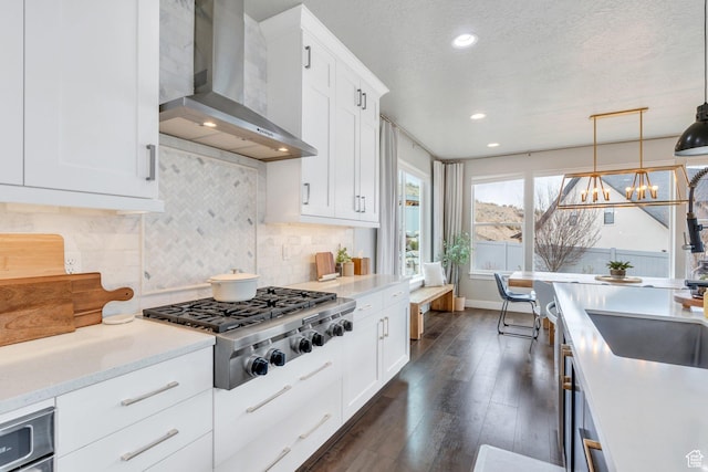 668 W Leroy Cir, Saratoga Springs, UT 84045 - kitchen featuring stainless steel gas cooktop, wall chimney exhaust hood, white cabinets, decorative backsplash, and dark wood-type flooring