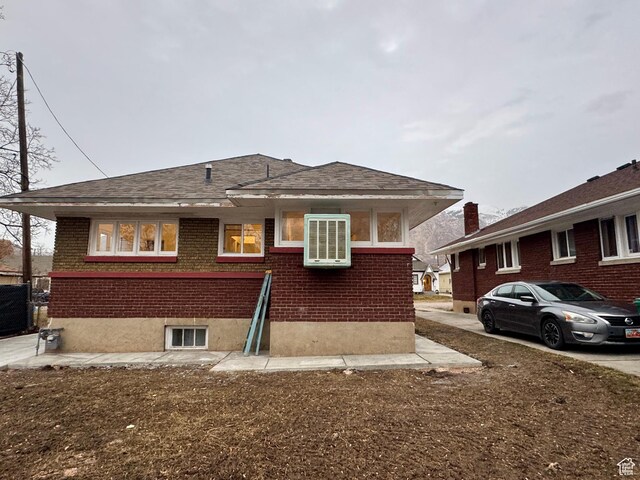2721 Gramercy Ave, Ogden, UT 84403 - exterior space with brick siding, central AC unit, and roof with shingles