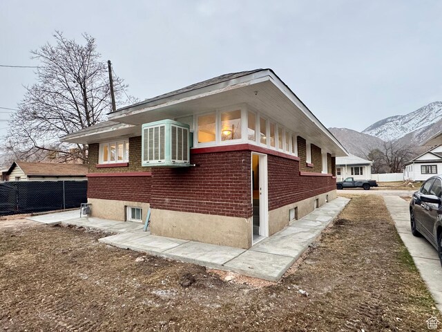 2721 Gramercy Ave, Ogden, UT 84403 - view of property exterior featuring a mountain view, brick siding, and fence