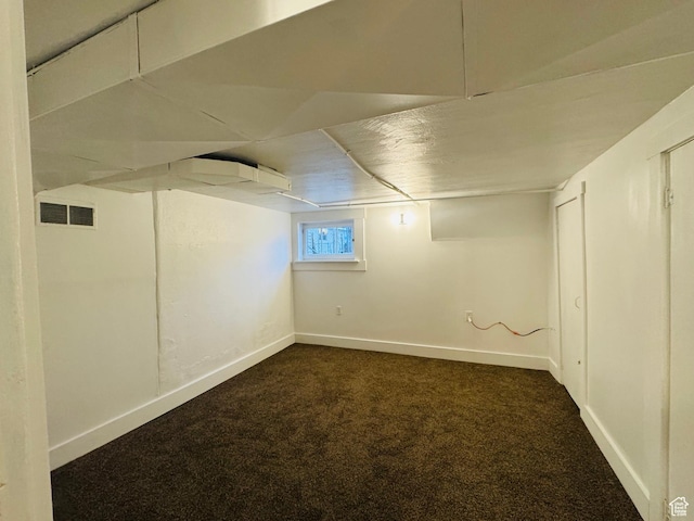 2721 Gramercy Ave, Ogden, UT 84403 - below grade area with baseboards, visible vents, and dark carpet