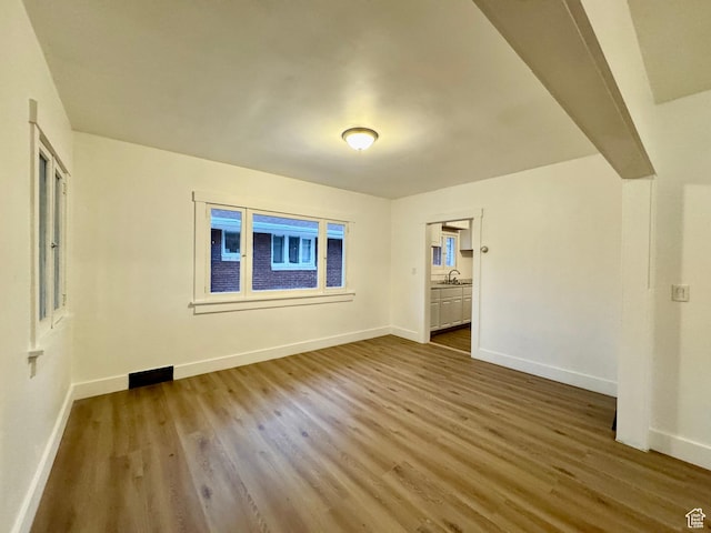 2721 Gramercy Ave, Ogden, UT 84403 - unfurnished room with dark wood-style floors, baseboards, and a sink