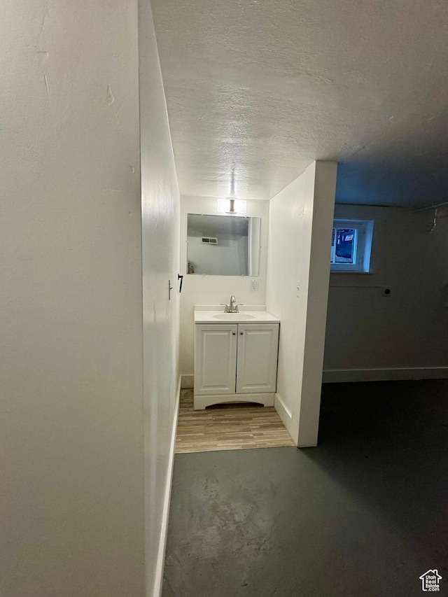 2721 Gramercy Ave, Ogden, UT 84403 - bathroom with vanity, wood finished floors, visible vents, baseboards, and a textured ceiling