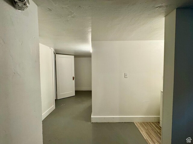 2721 Gramercy Ave, Ogden, UT 84403 - hall with a textured ceiling, concrete floors, and baseboards
