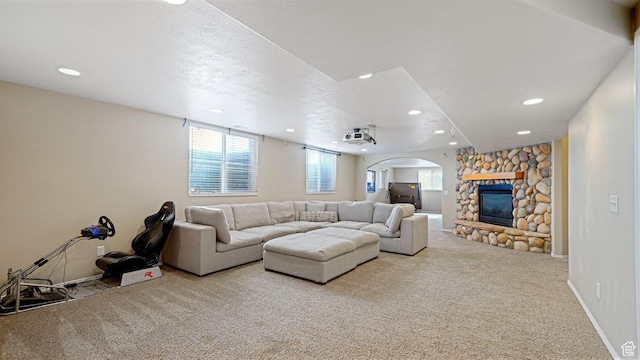 unfurnished living room with carpet, a textured ceiling, and a fireplace