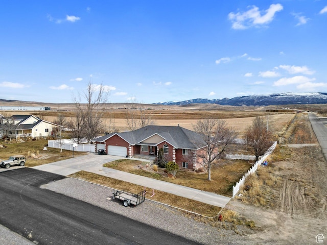 view of front of house featuring a garage and a mountain view