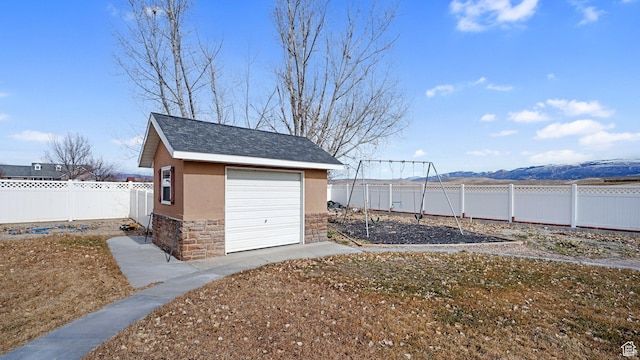 view of outdoor structure with a mountain view and a garage