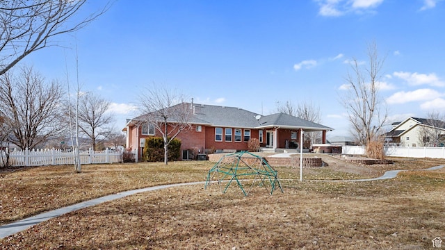 rear view of property featuring a yard