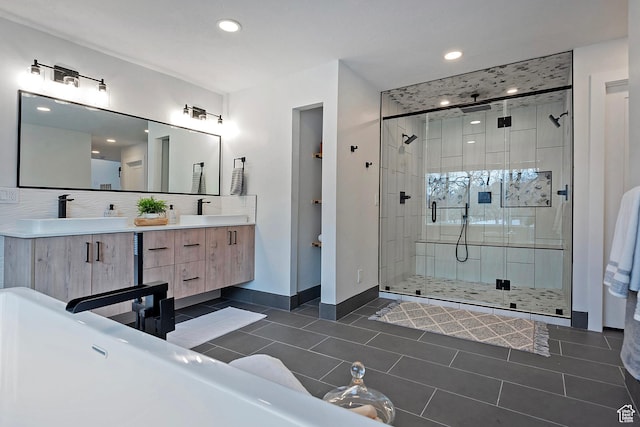 full bath featuring a sink, tile patterned flooring, and a stall shower