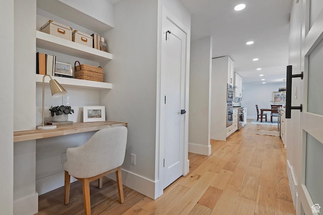hallway with recessed lighting, baseboards, and light wood-style floors