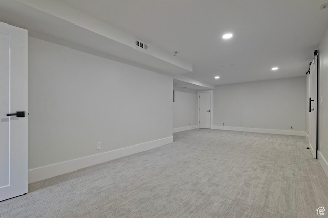 finished below grade area with baseboards, light colored carpet, recessed lighting, and visible vents