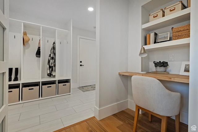 mudroom with recessed lighting, baseboards, wood finished floors, and built in study area