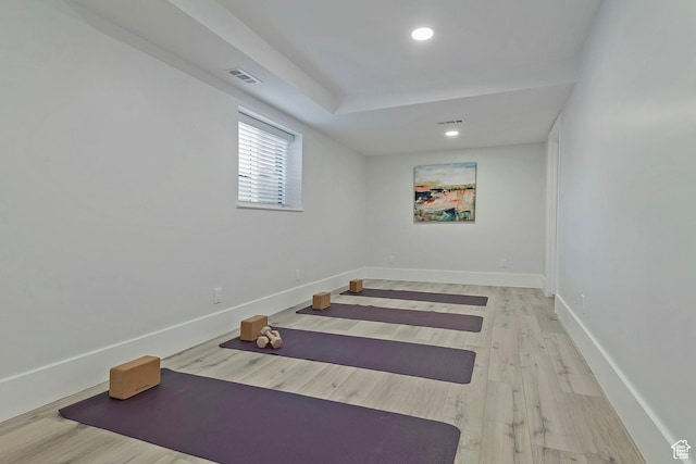 workout area with recessed lighting, baseboards, visible vents, and wood finished floors