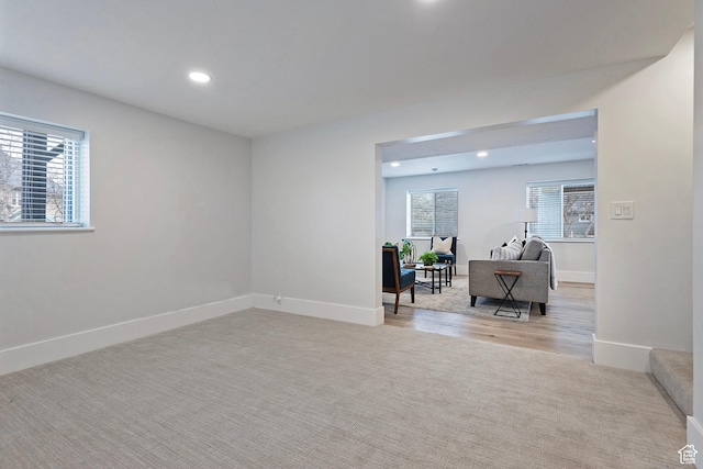 interior space with plenty of natural light, recessed lighting, baseboards, and light colored carpet