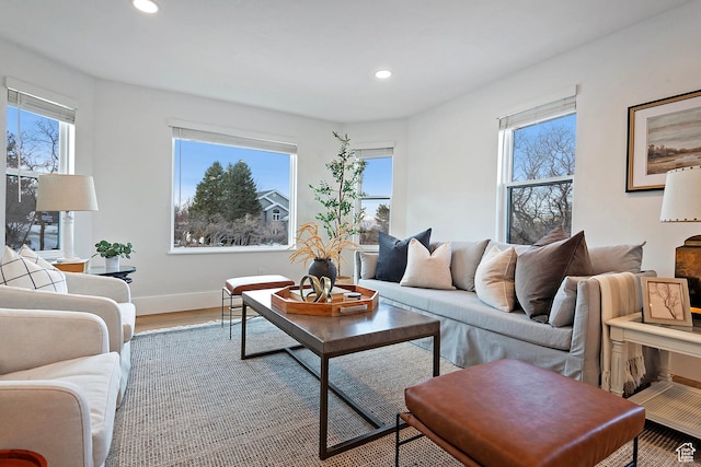 living room featuring baseboards, recessed lighting, and wood finished floors