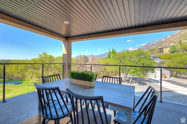 view of patio / terrace featuring outdoor dining area and a mountain view