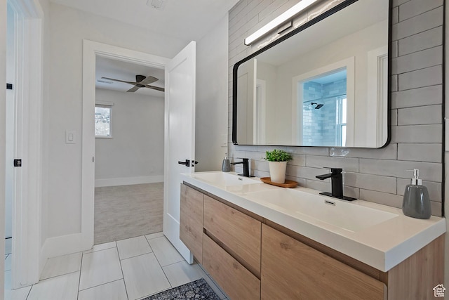 full bath featuring baseboards, a sink, ceiling fan, and backsplash
