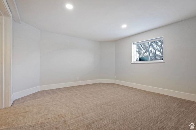 spare room with recessed lighting, carpet, and baseboards