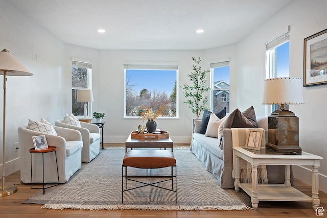 living room with a healthy amount of sunlight, baseboards, recessed lighting, and wood finished floors