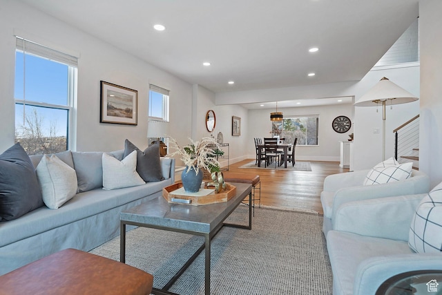 living room with recessed lighting, baseboards, and light wood finished floors
