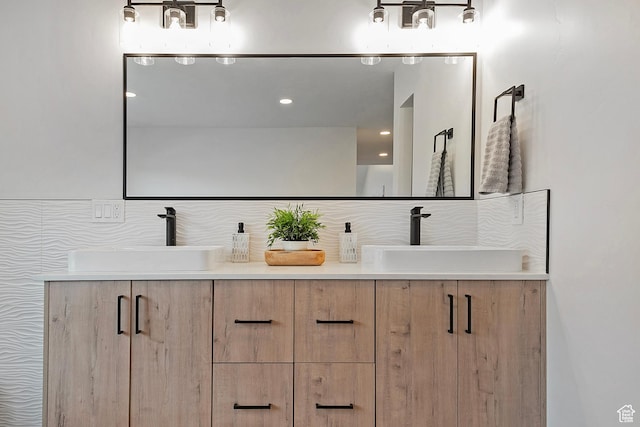 full bath with a sink and double vanity