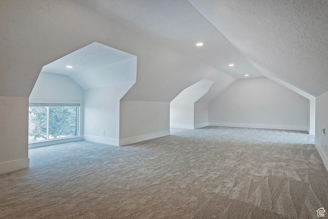 bonus room featuring carpet floors, recessed lighting, a textured ceiling, and vaulted ceiling