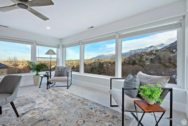 sunroom / solarium featuring visible vents, recessed lighting, a mountain view, and baseboards