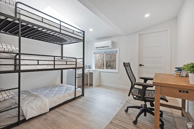 bedroom with baseboards, a wall mounted AC, wood finished floors, and vaulted ceiling