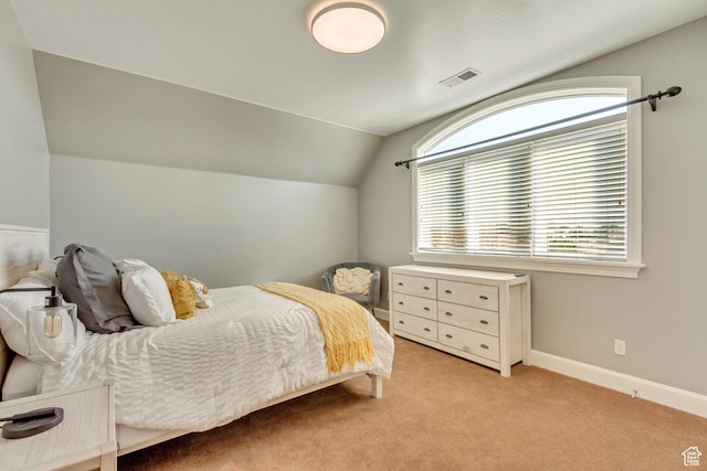 carpeted bedroom featuring vaulted ceiling