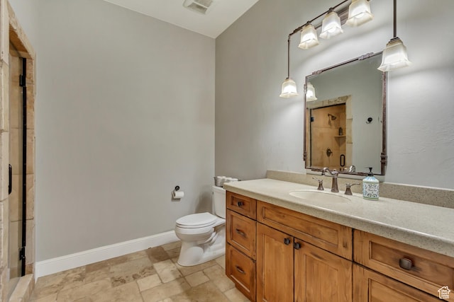 bathroom with vanity, toilet, and a shower with door