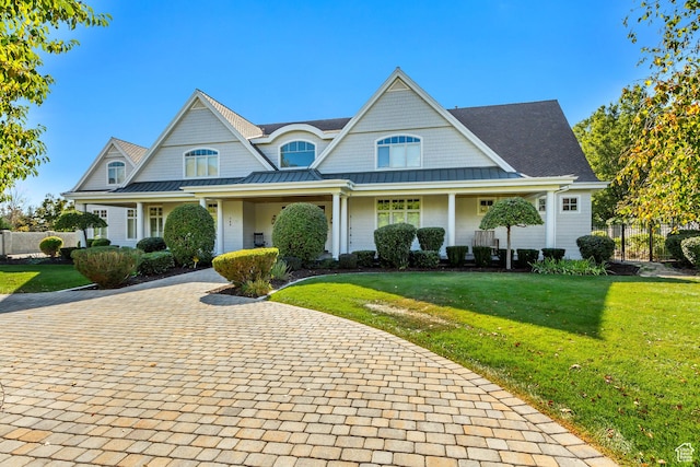 view of front of house featuring a front yard and covered porch