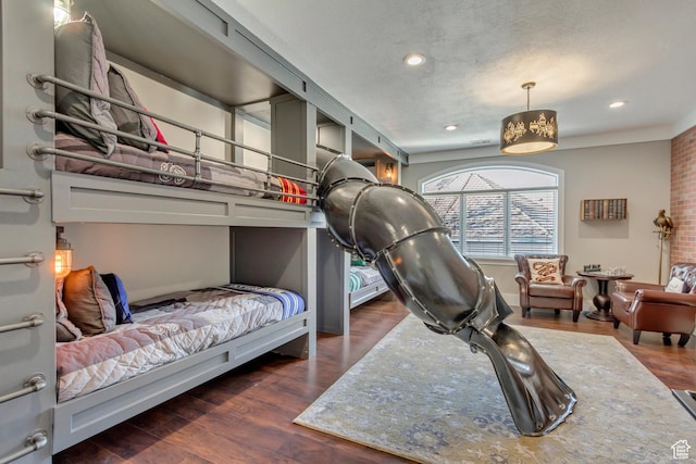 bedroom featuring dark wood-type flooring and a textured ceiling