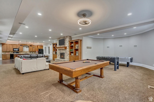 rec room with pool table, crown molding, light colored carpet, and a fireplace